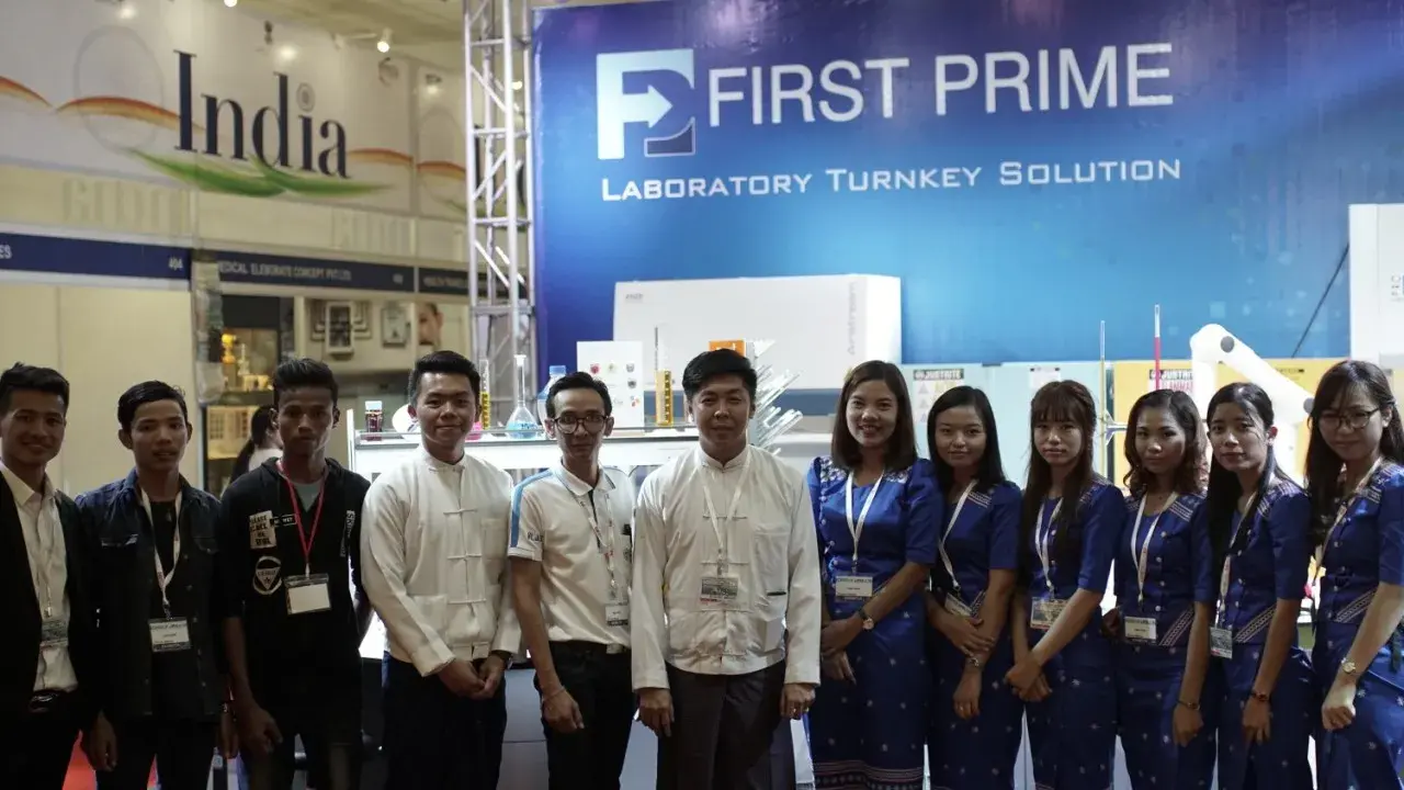 The FIRST PRIME team lined up in front of the Laboratory Turnkey Solution exhibition booth