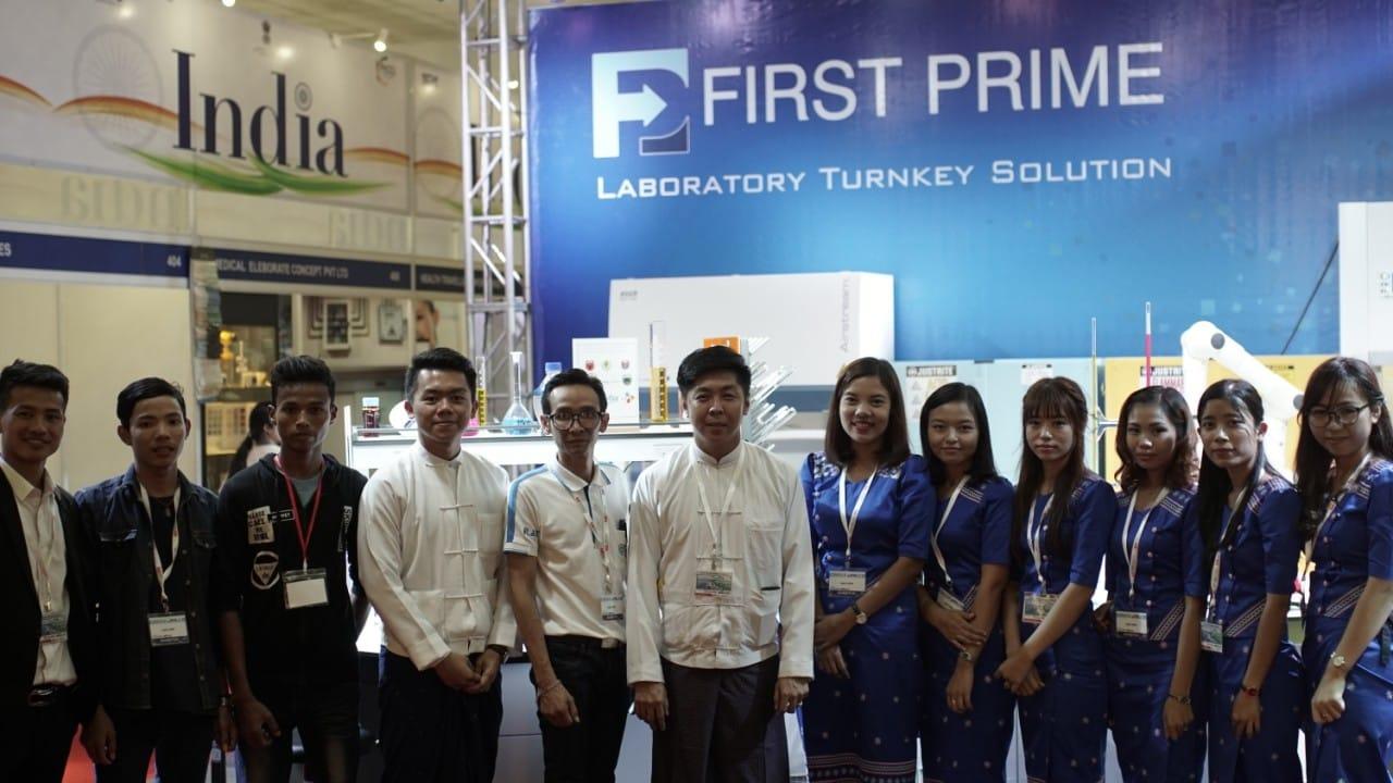 The full FIRST PRIME team in front of the Laboratory Turnkey Solution booth backdrop