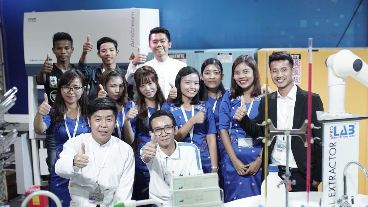 FIRST PRIME staff group photo beside the fume hood and safety storage display