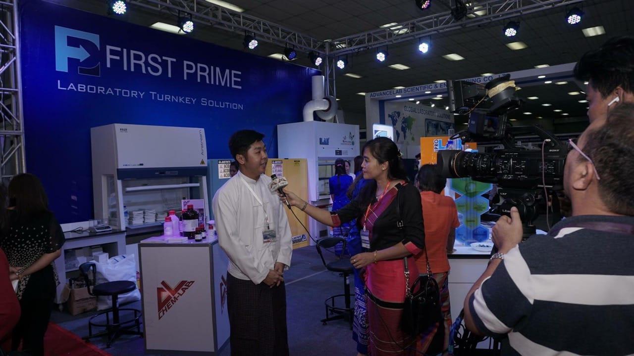 A FIRST PRIME representative being interviewed by a television crew at the stand