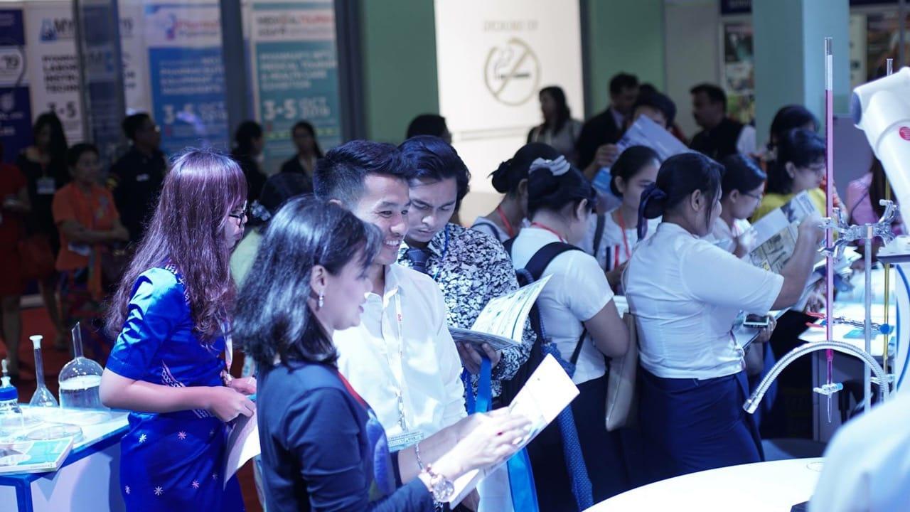 Visitors gathered at the FIRST PRIME booth reading product brochures