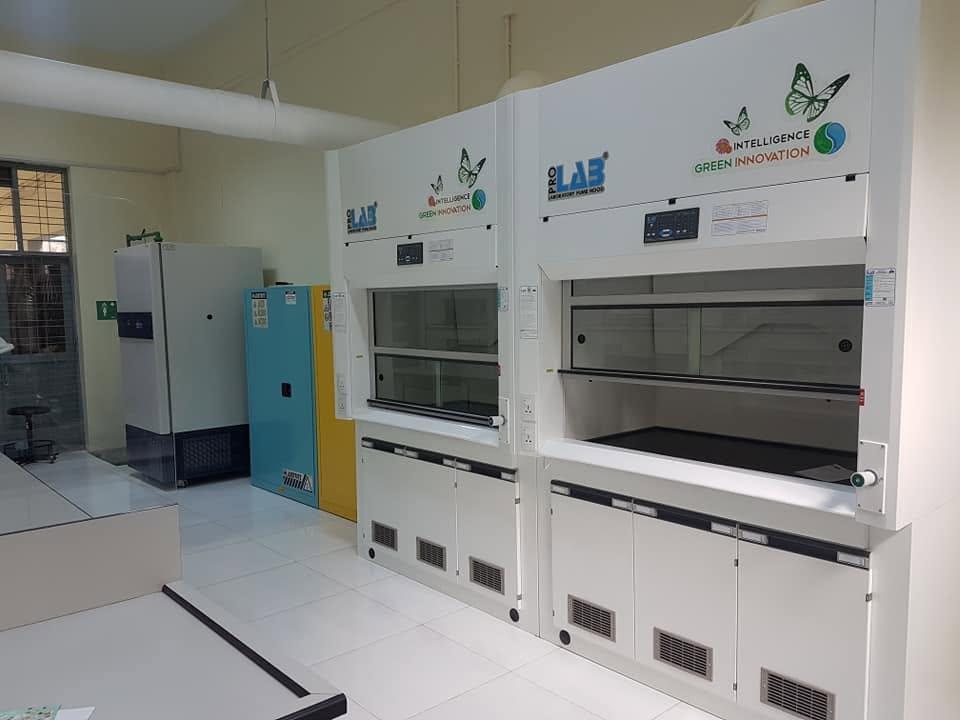The Micro Lab after renovation — two ProLAB fume hoods and Justrite safety storage cabinets on a tiled floor